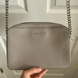 Michael Kors 
Grey Crossbody adjustable strap . Silver chain .Like new!